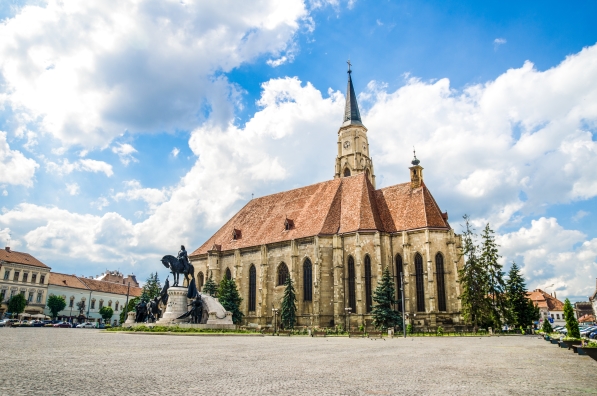 Cluj Napoca Unirii Square with the medieval gothic St Michael Church and the statue of Matei Corvin or Matias